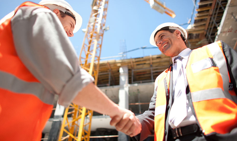 Engineers handshake on construction project